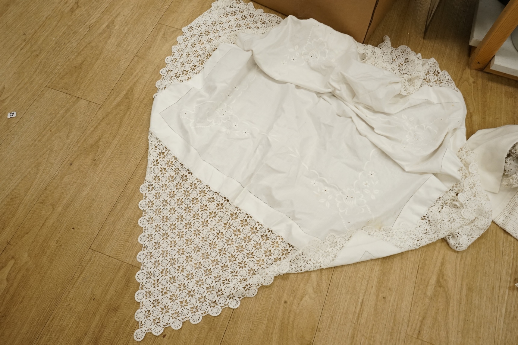 A collection of crochet, embroidered and damask linen table cloths and napkins